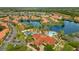 Aerial view of a community featuring a lake, pool, clubhouse, and lush landscaping at 141 Pompano Beach Dr, Kissimmee, FL 34746