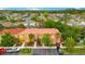 Aerial view of townhomes with red tile roofs in a community with lush landscaping at 141 Pompano Beach Dr, Kissimmee, FL 34746