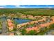 Aerial view of a townhome community surrounding a lake with lush green landscaping at 141 Pompano Beach Dr, Kissimmee, FL 34746