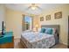 Comfortable bedroom with a queen-sized bed, side table, and natural light at 141 Pompano Beach Dr, Kissimmee, FL 34746