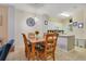 Dining area with wooden table and chairs adjacent to a modern kitchen at 141 Pompano Beach Dr, Kissimmee, FL 34746