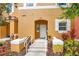 Close-up of front entrance featuring a white door, decorative plants, and the unit number at 141 Pompano Beach Dr, Kissimmee, FL 34746