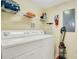 Laundry room with stacked washer and dryer and overhead storage at 141 Pompano Beach Dr, Kissimmee, FL 34746