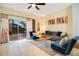 Bright living room with stylish decor, a ceiling fan, and sliding glass doors leading to the patio at 141 Pompano Beach Dr, Kissimmee, FL 34746