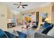 Cozy living room featuring neutral walls, comfortable seating, ceiling fan, and sliding glass doors at 141 Pompano Beach Dr, Kissimmee, FL 34746