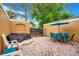 Outdoor patio area featuring a glass top table, blue chairs, an umbrella, and white chairs at 141 Pompano Beach Dr, Kissimmee, FL 34746