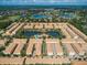 Aerial view of the community showcasing the pool, lake, and lush green surroundings at 1447 Lake George Dr, Lake Mary, FL 32746