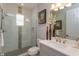 This bathroom features a white vanity, framed mirror, and a glass enclosed walk-in shower with tile surround at 1447 Lake George Dr, Lake Mary, FL 32746