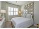 Well-lit bedroom with a neutral color scheme, decorative headboard and ceiling fan at 1447 Lake George Dr, Lake Mary, FL 32746