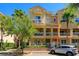 Charming townhome with balconies and lush landscaping, creating a warm and inviting curb appeal at 1447 Lake George Dr, Lake Mary, FL 32746