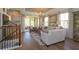 This living room features hardwood floors, a staircase, and sliding glass doors opening to an outdoor balcony at 1447 Lake George Dr, Lake Mary, FL 32746