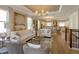 Open-concept living room flowing into the kitchen and dining area with hardwood floors and neutral decor at 1447 Lake George Dr, Lake Mary, FL 32746