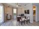 Bright home office with wood-look tile flooring, ceiling fan, and a door leading to the outside at 1447 Lake George Dr, Lake Mary, FL 32746