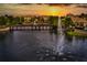 Scenic community pond with a fountain and a bridge at sunset providing a serene atmosphere at 1447 Lake George Dr, Lake Mary, FL 32746