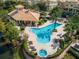 Aerial view of the community pool and amenities, surrounded by lush landscaping and lounge areas at 1447 Lake George Dr, Lake Mary, FL 32746