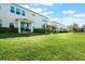 A backyard features a lawn with a covered porch and seating area, perfect for enjoying the outdoors at 15221 Sunrise Grove Ct, Winter Garden, FL 34787