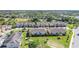 Aerial of backyard of townhomes featuring lush green space and mature trees at 15221 Sunrise Grove Ct, Winter Garden, FL 34787