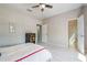 This bedroom features wood-look floors, neutral walls, modern decor, and lots of natural light at 15221 Sunrise Grove Ct, Winter Garden, FL 34787