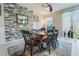 Elegant dining room with a modern light fixture, stone accent wall, and seating for six at 15221 Sunrise Grove Ct, Winter Garden, FL 34787