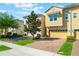 Inviting townhouse with a brick drive, manicured lawn, and an attached one car garage at 15221 Sunrise Grove Ct, Winter Garden, FL 34787