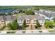 Beautiful townhome complex with manicured lawns and brick-paved driveways next to a serene lake at 15221 Sunrise Grove Ct, Winter Garden, FL 34787