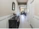 Welcoming hallway with neutral paint, decorative wood trim, and durable tile floors at 15221 Sunrise Grove Ct, Winter Garden, FL 34787