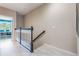 Upstairs hallway with white wood flooring and railings leading to bedrooms and other living spaces at 15221 Sunrise Grove Ct, Winter Garden, FL 34787