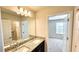 Bright bathroom featuring double sinks with granite counters and vanity at 16248 Saint Kitts Cir, Clermont, FL 34714