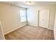 Cozy bedroom featuring neutral carpet, window, and closet at 16248 Saint Kitts Cir, Clermont, FL 34714