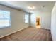 Neutral bedroom with two windows, carpet, and access to an ensuite bathroom at 16248 Saint Kitts Cir, Clermont, FL 34714