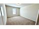 Bright bedroom with neutral carpet, a window, and ample natural light at 16248 Saint Kitts Cir, Clermont, FL 34714