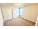 A bright bedroom with neutral carpet, closet and a window at 16248 Saint Kitts Cir, Clermont, FL 34714