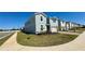 Landscaped lawn surrounding the side exterior of a two-story home in a residential neighborhood at 16248 Saint Kitts Cir, Clermont, FL 34714