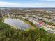 Beautiful aerial view of the home with a serene lake, lush trees, and surrounding neighborhood at 16805 Sunrise Vista Dr, Clermont, FL 34714