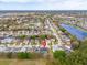 Overhead view shows a property among a suburban landscape featuring a serene lake and numerous residential homes at 16805 Sunrise Vista Dr, Clermont, FL 34714