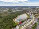 Stunning aerial shot showcasing the home near a peaceful lake and surrounded by mature trees at 16805 Sunrise Vista Dr, Clermont, FL 34714