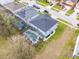 Aerial view of a home with a screened-in pool area next to other residences and neighborhood streets at 16805 Sunrise Vista Dr, Clermont, FL 34714