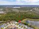 Gorgeous aerial view of the home with a backdrop of lush greenery and a tranquil lake at 16805 Sunrise Vista Dr, Clermont, FL 34714