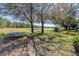 Spacious backyard with trees, swing set and trampoline overlooking a scenic lake at 16805 Sunrise Vista Dr, Clermont, FL 34714