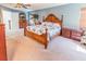 Bright, spacious bedroom features elegant wood furniture and a ceiling fan at 16805 Sunrise Vista Dr, Clermont, FL 34714