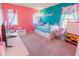 bedroom with pink and turquoise walls and colorful decor at 16805 Sunrise Vista Dr, Clermont, FL 34714