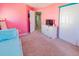 Bedroom with television, dresser, and pastel pink walls at 16805 Sunrise Vista Dr, Clermont, FL 34714