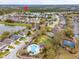 Nice aerial view showcasing the community pool, playground, basketball court, and nearby lake at 16805 Sunrise Vista Dr, Clermont, FL 34714