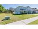 View of the front of a beautiful home with lush green lawn and side yard in a quiet neighborhood at 16805 Sunrise Vista Dr, Clermont, FL 34714