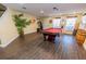 Spacious game room with a pool table, stylish decor, and wood flooring, perfect for entertaining guests at 16805 Sunrise Vista Dr, Clermont, FL 34714