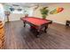 Spacious game room with a pool table, stylish decor, and wood flooring, perfect for entertaining guests at 16805 Sunrise Vista Dr, Clermont, FL 34714