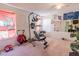 Finished home gym featuring workout equipment, weights, and sports-themed wall decor at 16805 Sunrise Vista Dr, Clermont, FL 34714