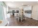 Open kitchen and dining area with white cabinetry, a backsplash, and modern lighting at 16805 Sunrise Vista Dr, Clermont, FL 34714