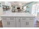 Kitchen island with white cabinets overlooks the dining area and living room at 16805 Sunrise Vista Dr, Clermont, FL 34714