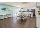 Bright kitchen and dining area with white cabinets, modern appliances, and view of the pool at 16805 Sunrise Vista Dr, Clermont, FL 34714